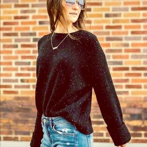 Black ribbed sweater with color flecks throughout